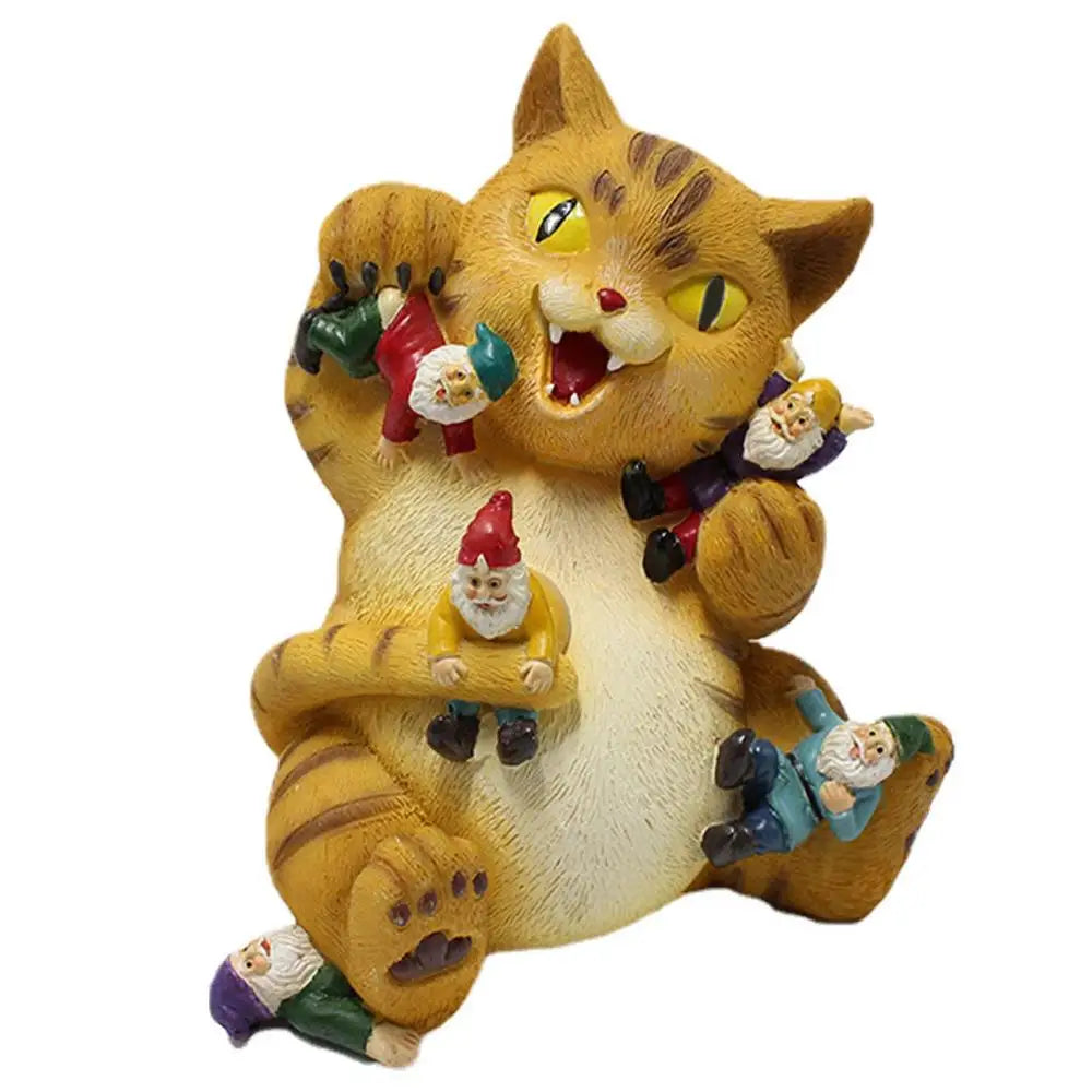 A playful, chubby cat figurine holds multiple colorful garden gnomes, appearing cheerful and mischievous. The cat's expression is joyful, surrounded by the tiny figures.