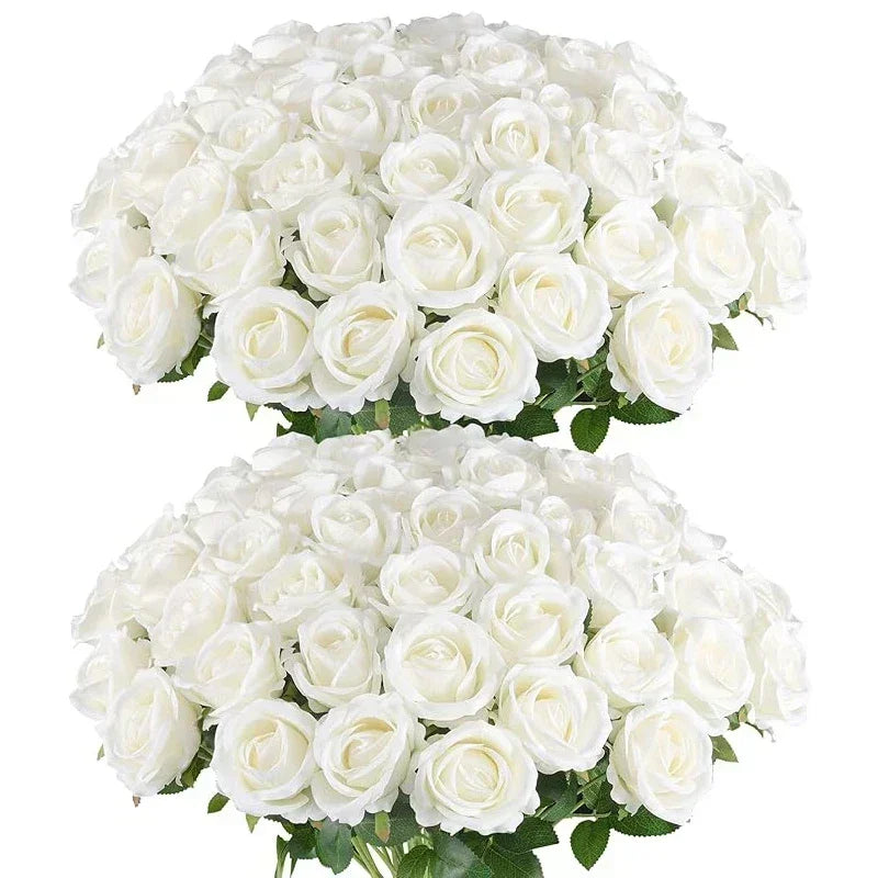 A large bouquet of white roses with lush green leaves, arranged in two stacked clusters, creating an elegant and full floral display.