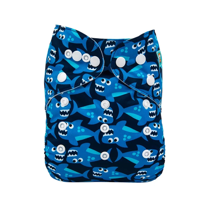 Blue cloth diaper with a playful shark pattern featuring smiling sharks and adjustable white snap closures.