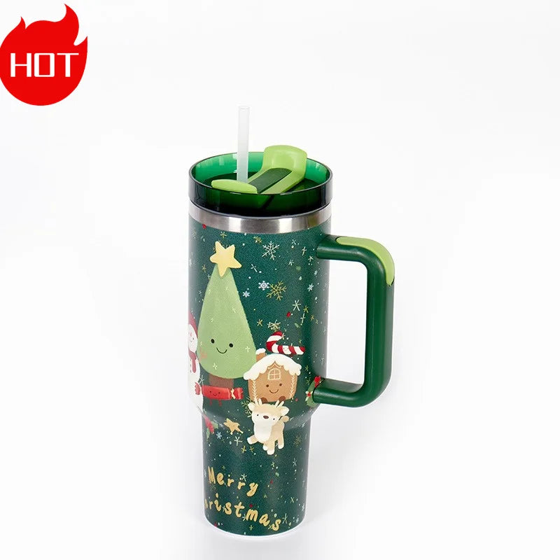 Green travel mug with a festive Christmas design, including a tree, Santa, and a reindeer, and featuring a green lid, straw, and "Merry Christmas" text. Red "HOT" label in the corner.