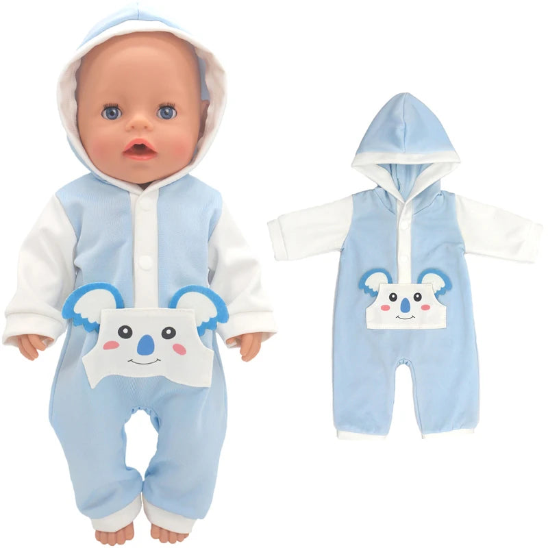 Doll wearing a blue hooded onesie with a smiling bear face pocket, next to the same outfit laid flat. The design features white sleeves and bear ears.