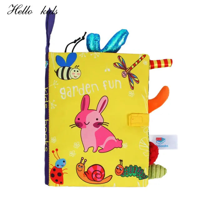 Colorful cloth book titled "Garden Fun" with playful illustrations of a pink rabbit, bee, ladybug, and other garden creatures. Textures and tabs for toddler engagement.