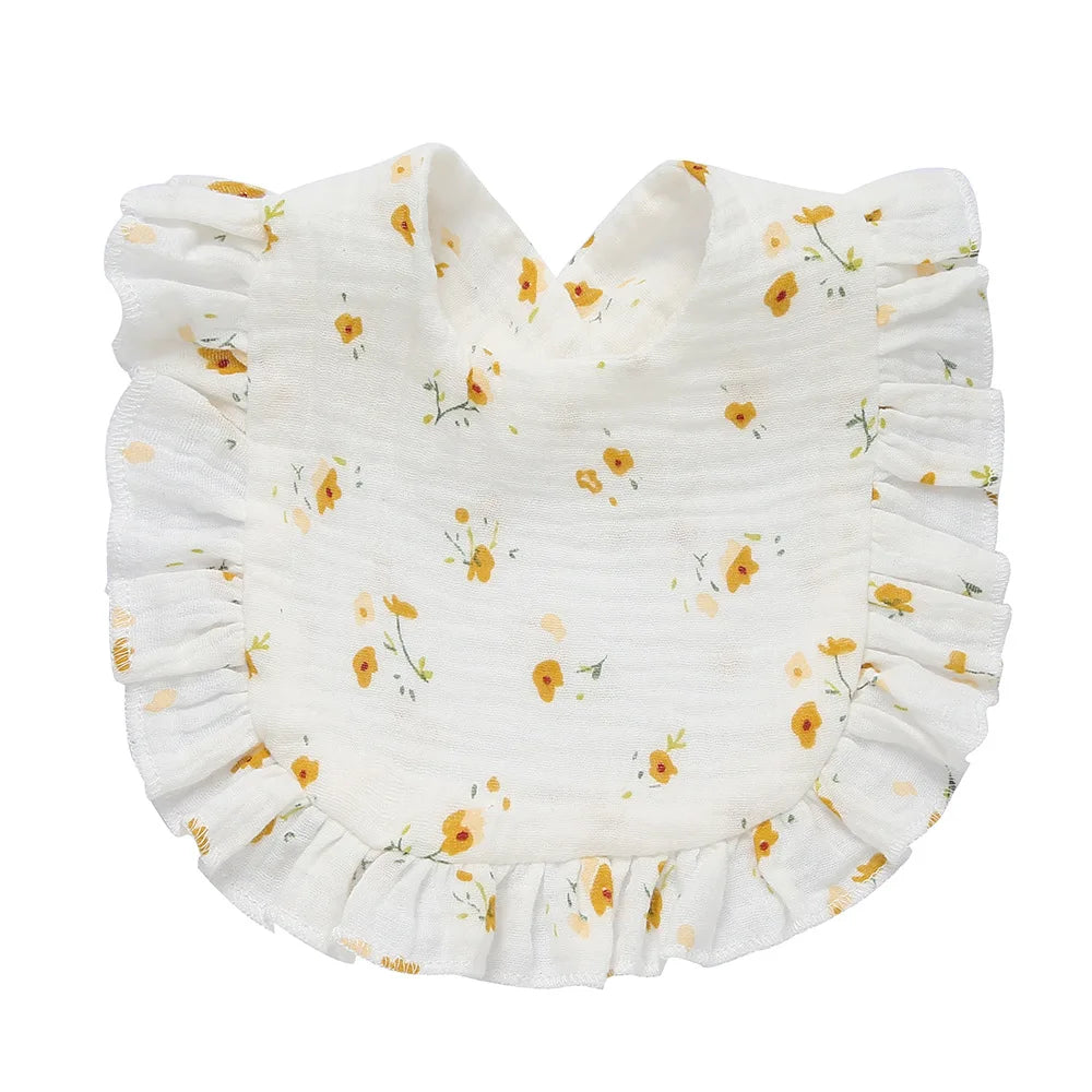 White baby bib with yellow floral pattern and ruffled edges. The design features small, scattered flowers, creating a charming and delicate look suitable for infants.