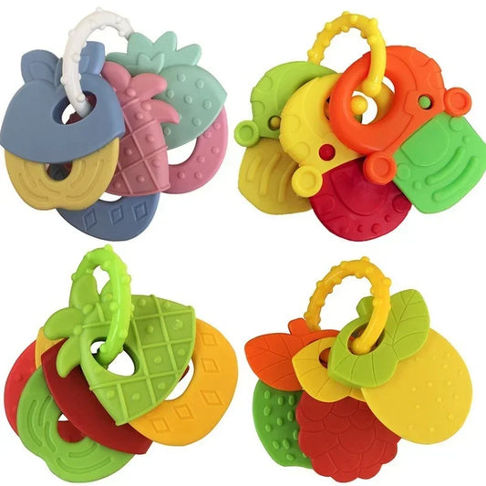 Colorful baby teething toys shaped like fruits, each with a textured surface. The toys are on loops for easy handling and feature various vibrant colors for visual interest.