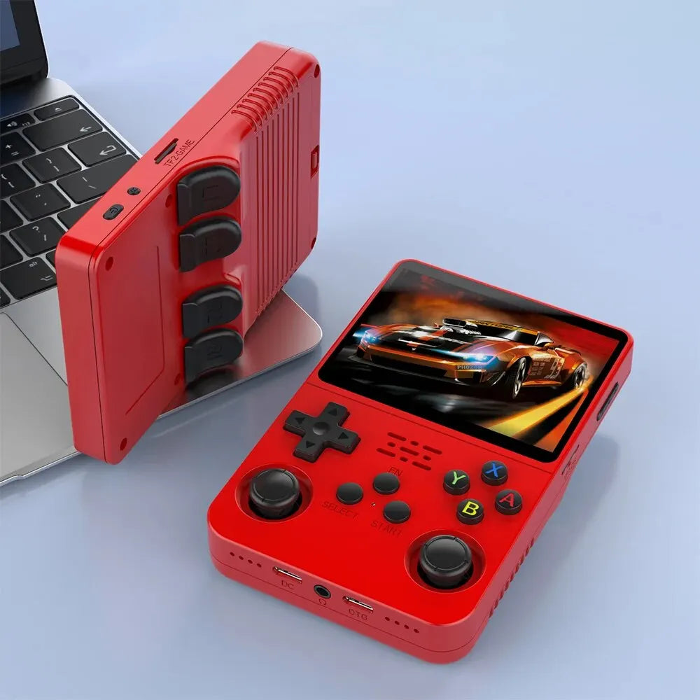 Two Faron R36S Retro Handheld Consoles - 64GB Games are displayed: one flat showing a racing game on its IPS screen, the other upright by a laptop keyboard. Both portable consoles feature buttons, joysticks, and ports.
