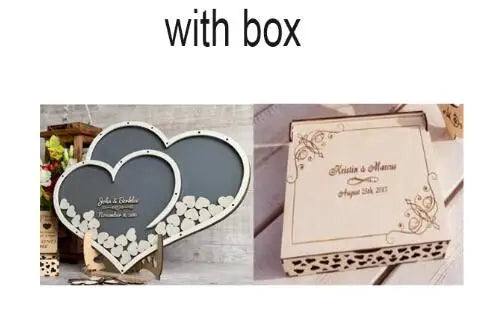 Heart-shaped guest book with wooden hearts, engraved with "Julie & Kaleb, November 11th," alongside a decorative box labeled "Kristin & Mason, August 12th, 2023."