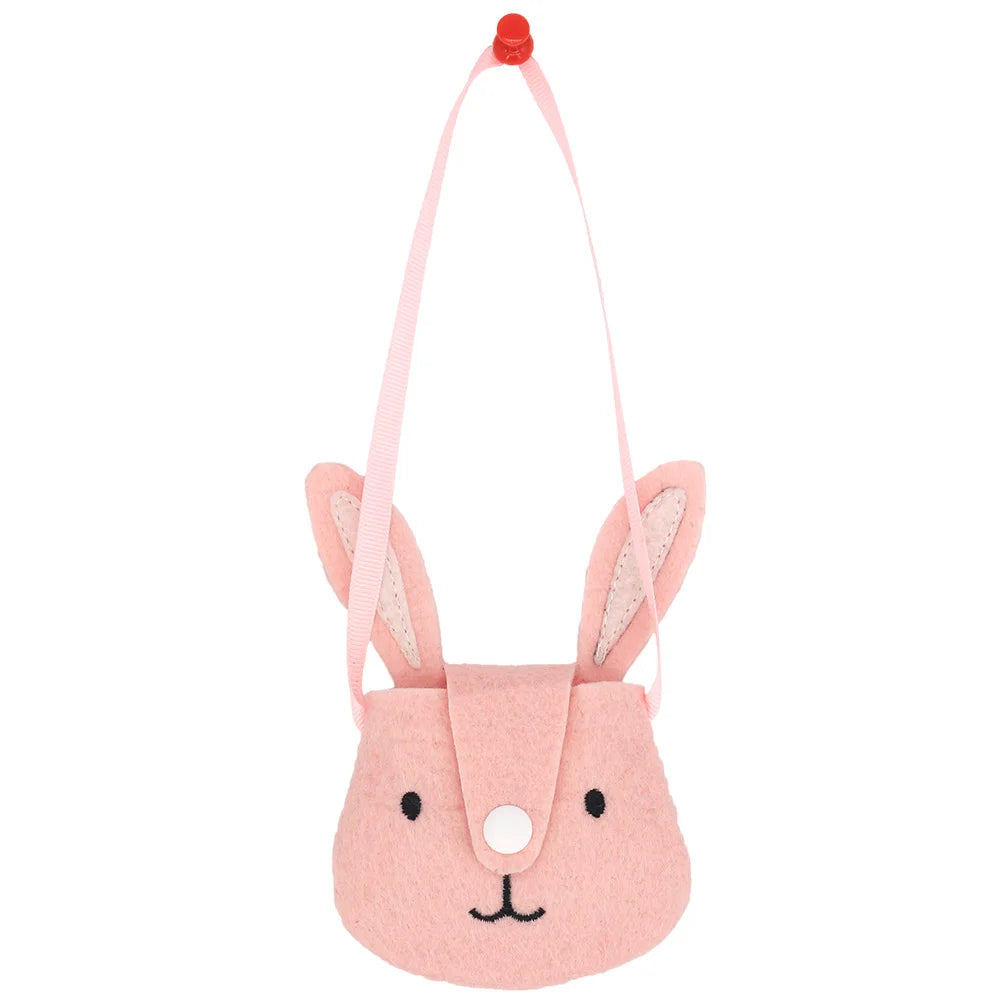 Pink felt bunny pouch with ears, a smiling face, button nose, and pink strap. The pouch is hanging on a red tack against a white background.