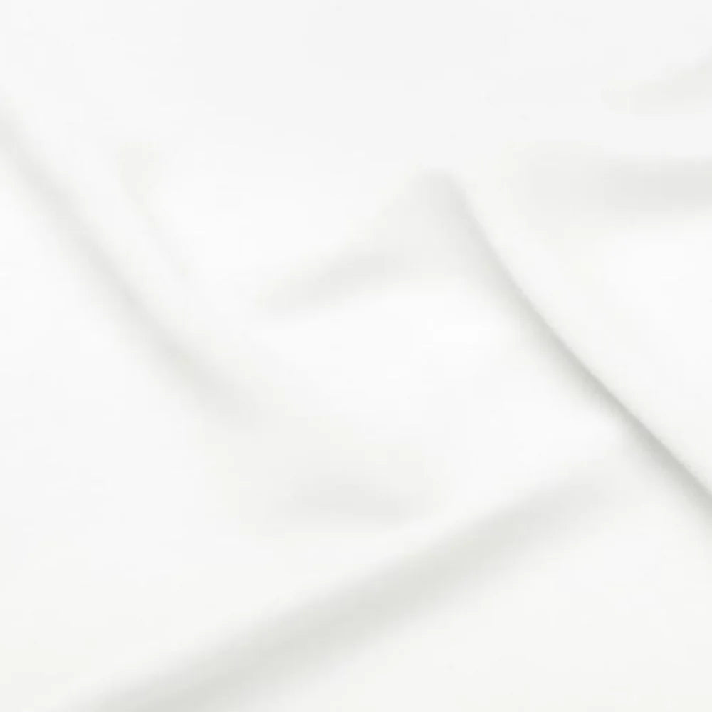 Close-up of a soft, smooth white fabric with gentle folds and a subtle sheen, creating a minimalistic, textured background.