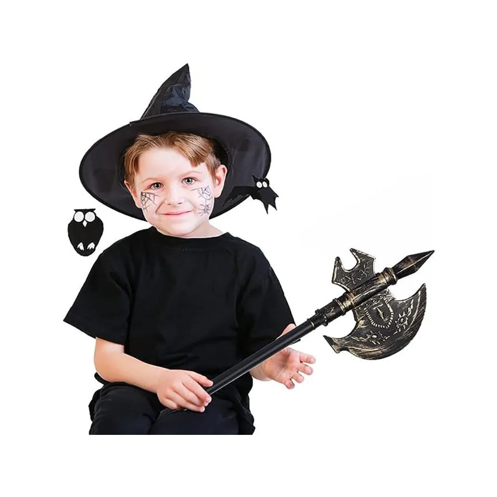 Young child wearing a witch hat and black outfit, with spider web face paint, holding a decorated battle axe. Owl and bat cutouts are on either side of the hat.