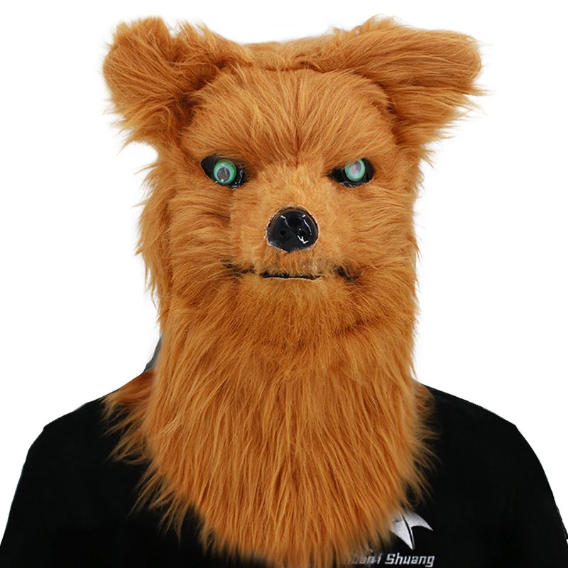A person in a realistic, furry orange dog mask with wide green eyes and a black nose, against a plain background. They wear a black shirt with a partial logo.