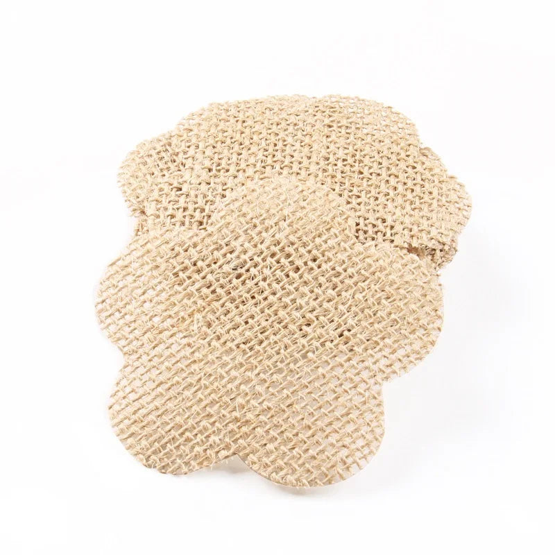 Two burlap coasters in the shape of flowers are stacked on a white background. The textured, woven material has a natural beige color, adding a rustic charm.