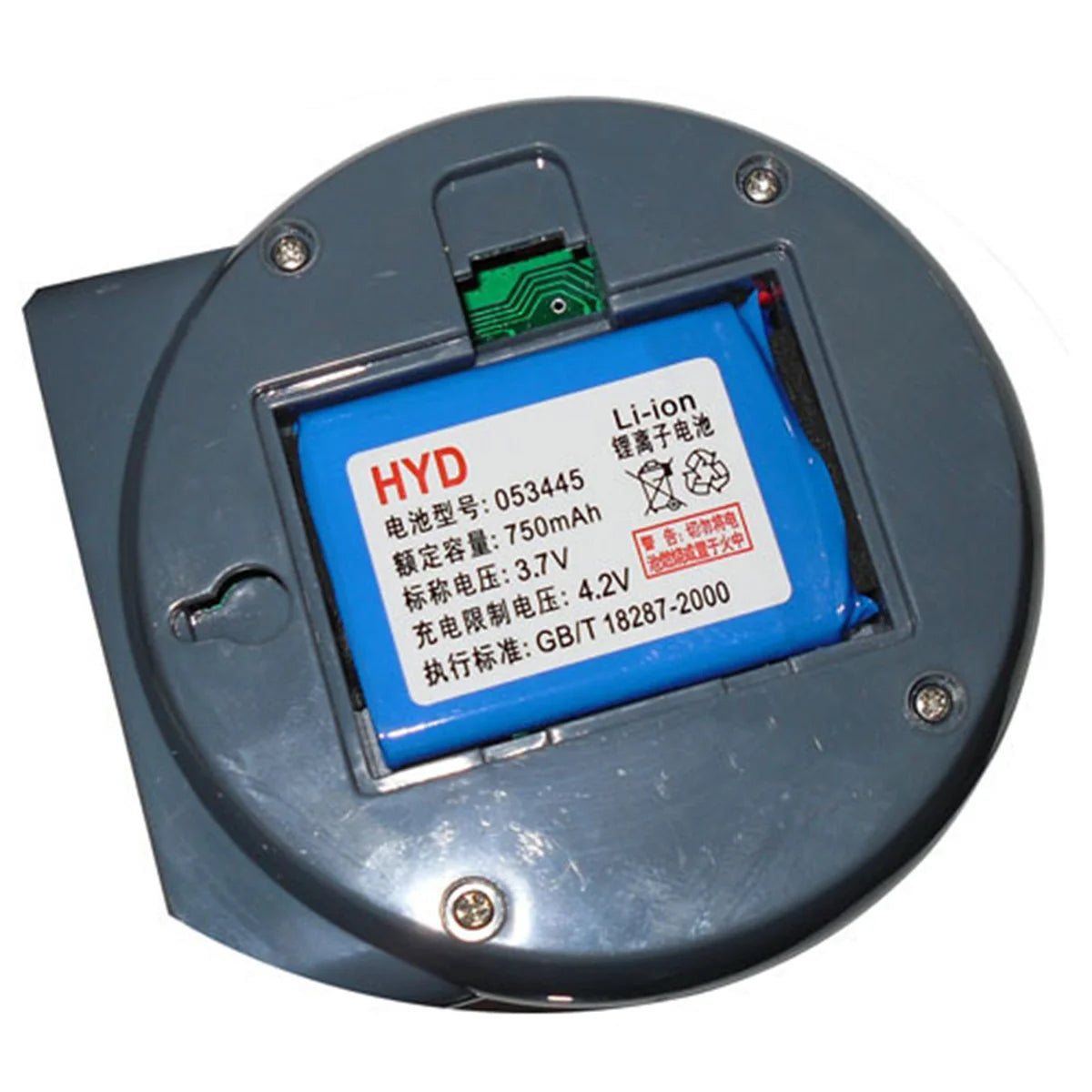Round Li-ion battery labeled HYD, model 053445, 750mAh, 3.7V in a grey casing. Noticeable green circuit and screws securing the cover.