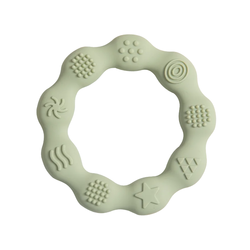 Green circular baby teether with varying textured patterns, including dots, swirls, and a star, designed for sensory stimulation and teething relief.