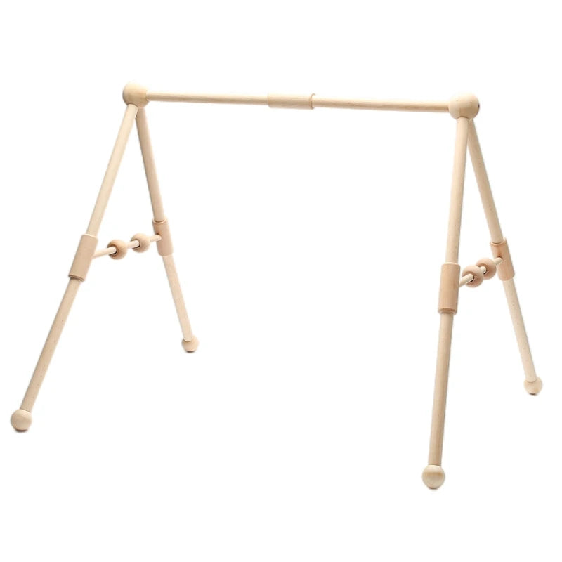 Wooden baby gym with an A-frame design featuring smooth rods and hanging rings for toys. The natural finish showcases simplicity and functionality in a minimalist style.