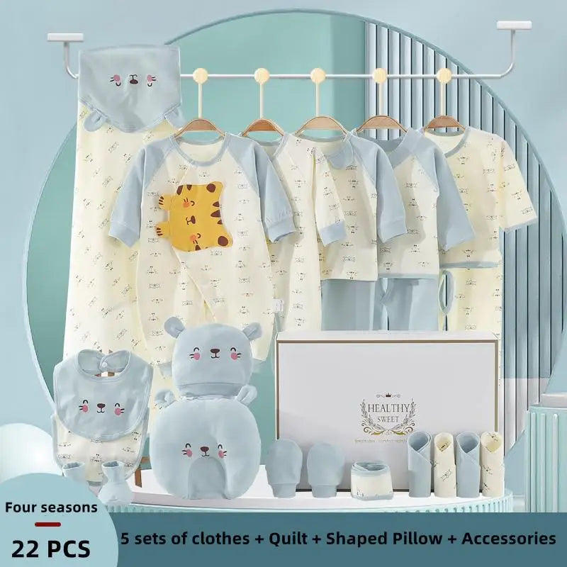 Baby gift set with 5 clothing sets, quilt, shaped pillow, and accessories. Includes yellow and blue outfits featuring cute animal designs, displayed with packaging and hanging decor.
