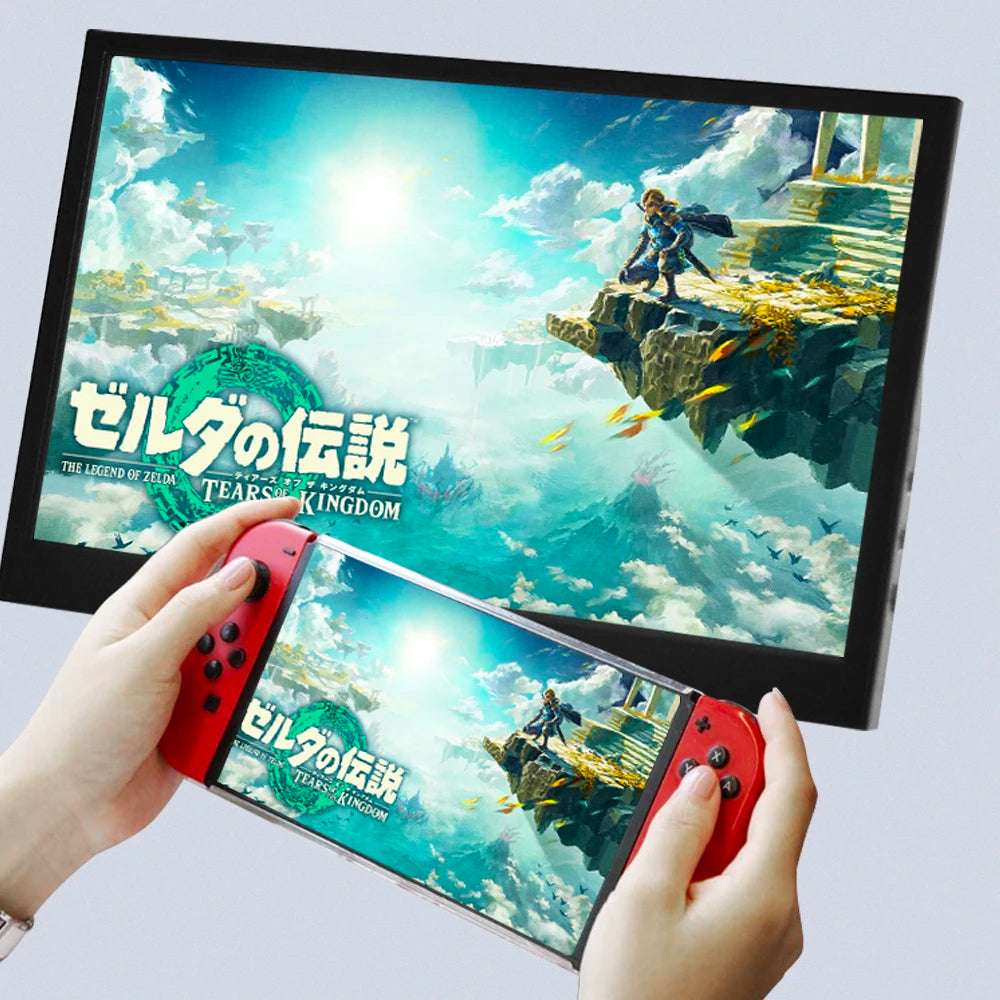 Hands holding a gaming console displaying "The Legend of Zelda: Tears of the Kingdom" with matching image mirrored on a larger monitor.
