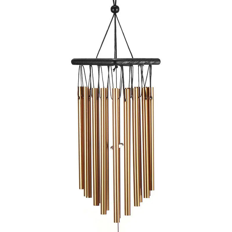Brass wind chime with multiple cylindrical tubes hanging from a black horizontal bar, creating a musical instrument suspended by a thin black cord.