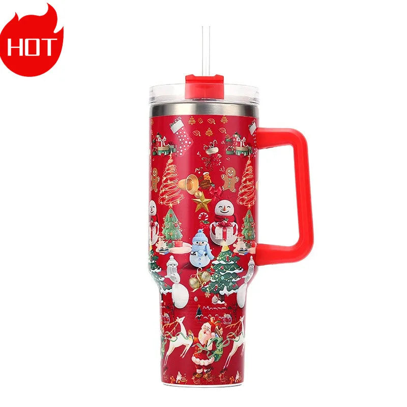 Red insulated mug with festive holiday designs, including Santa, snowmen, and Christmas trees. Features a clear lid with a straw and red handle.