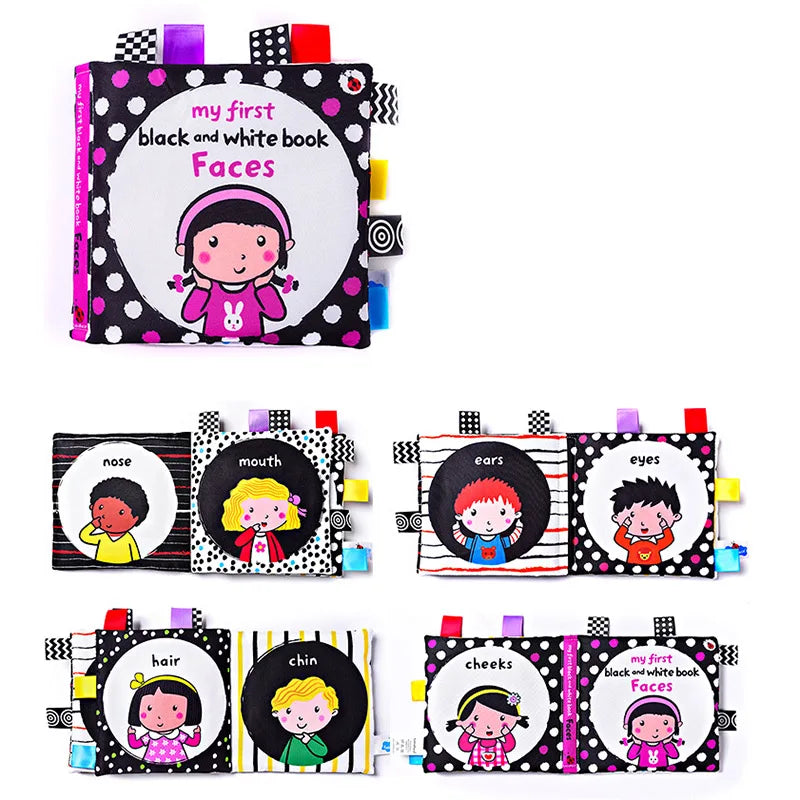 Colorful children's cloth book titled "My First Black and White Book: Faces" with illustrated pages showing diverse kids' features like nose, mouth, ears, eyes, hair, chin, and cheeks.