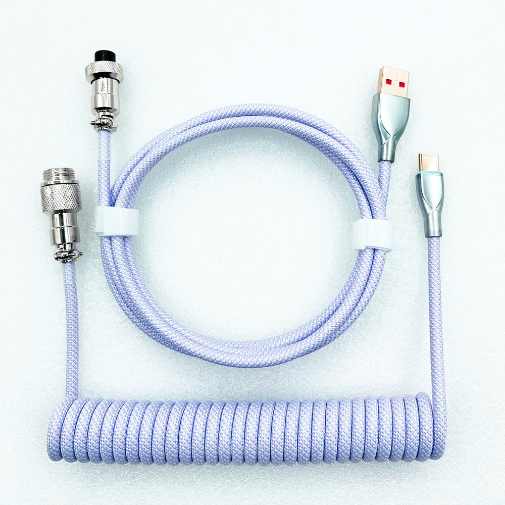 Lavender coiled USB-C cable with silver connectors, featuring a detachable aviator connector on one end and a standard USB plug on the other, laid on a light surface.