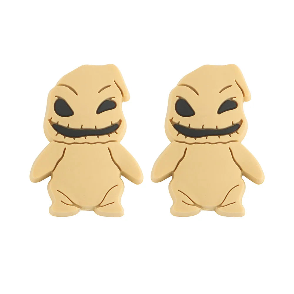 Two cartoonish, beige figures with stitched mouths and hollow eyes stand side by side, resembling playful interpretations of spooky characters against a plain background.
