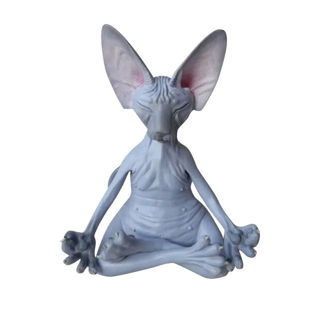 A hairless cat figurine with large ears, sitting cross-legged in a meditative pose, eyes closed, exhibiting a serene expression with detailed wrinkles on its body.