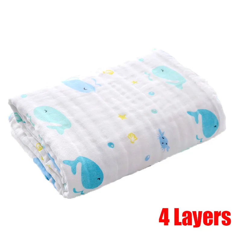 Folded white blanket with blue whale and yellow starfish prints, labeled "4 Layers" in bold red text.