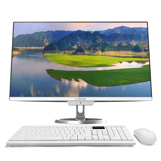 A sleek computer monitor displaying a scenic landscape of mountains and a river, set above a white keyboard and mouse on a plain white background.