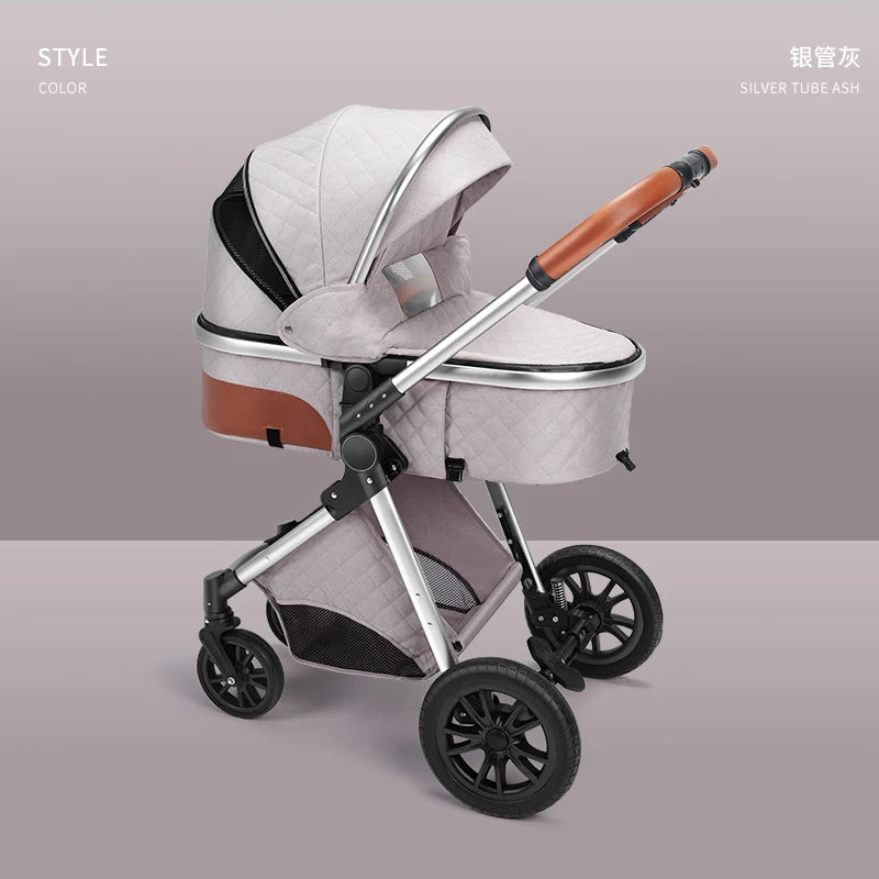 Modern baby stroller in soft gray, quilted fabric with a silver frame and brown handle. Features include large black wheels, a hood, and a basket underneath against a light background.