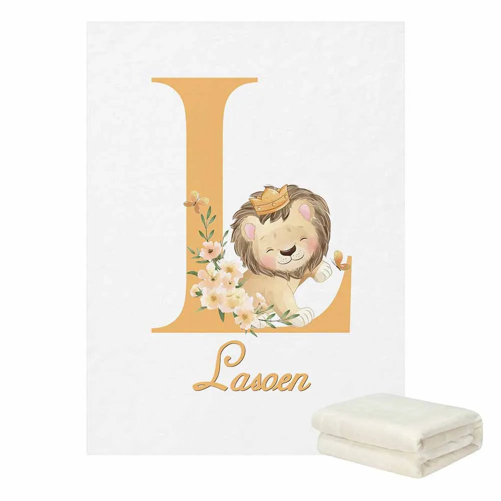 Letter "L" featuring a cute lion with a crown, surrounded by flowers. Below, the name "Laseen" is written in elegant script. Two folded blankets are in the corner.