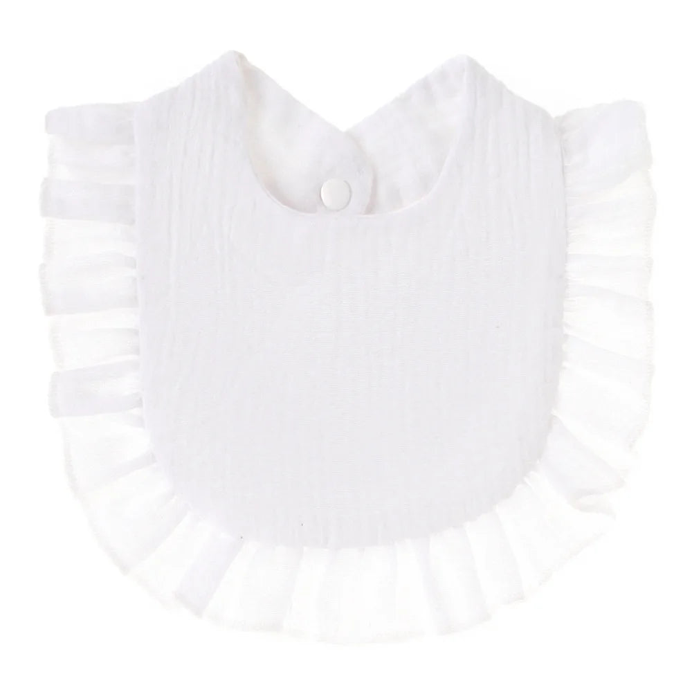 A white baby bib with a frilled edge and a button closure at the neck, made of soft fabric, perfect for protecting clothing during feeding.