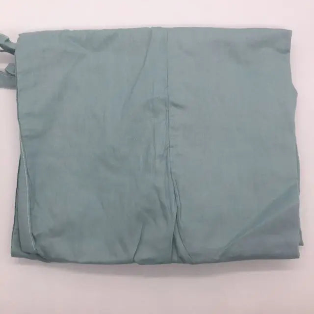 Folded light blue fabric with visible creases, laid flat against a white background.