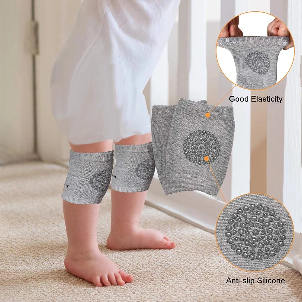 A toddler wearing gray knee pads with anti-slip silicone grips crawls on a carpet. Insets highlight the pads' good elasticity and silicone texture for added safety.