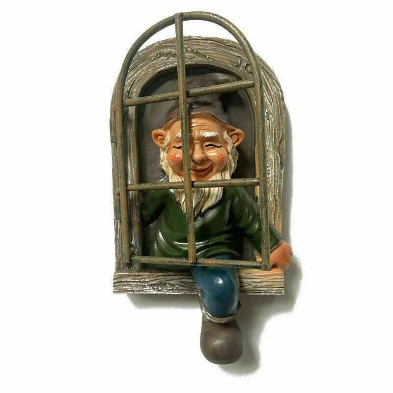 A whimsical gnome figurine with a big grin sits inside a rustic window frame with bars, wearing a green sweater, blue pants, and a pointed hat, looking out playfully.