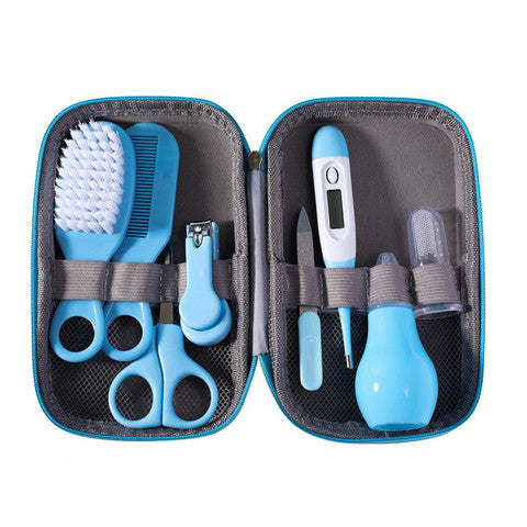 A baby grooming kit in a blue zippered case. Includes a brush, comb, nail clippers, scissors, thermometer, dropper, and nasal aspirator, all neatly organized in elastic bands.