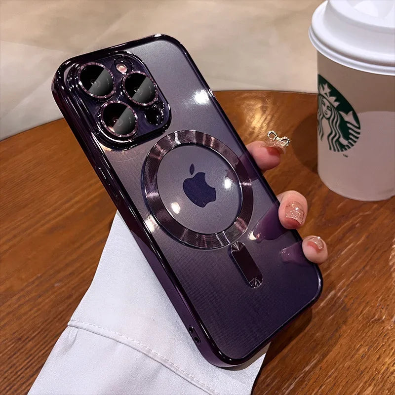 Person holding a purple iPhone with a transparent case displaying the Apple logo, next to a Starbucks cup on a wooden table.