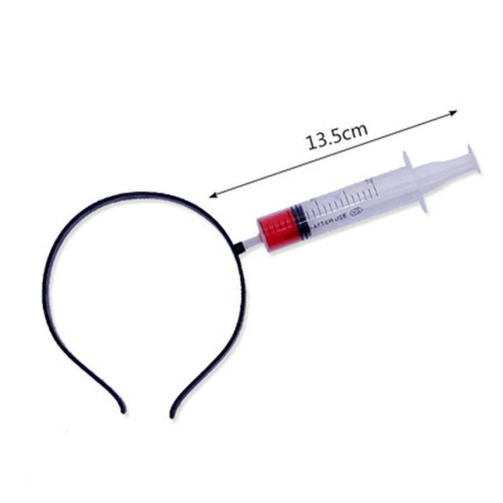 A novelty headband featuring a 13.5 cm syringe design with red liquid inside, attached to a black curved band.