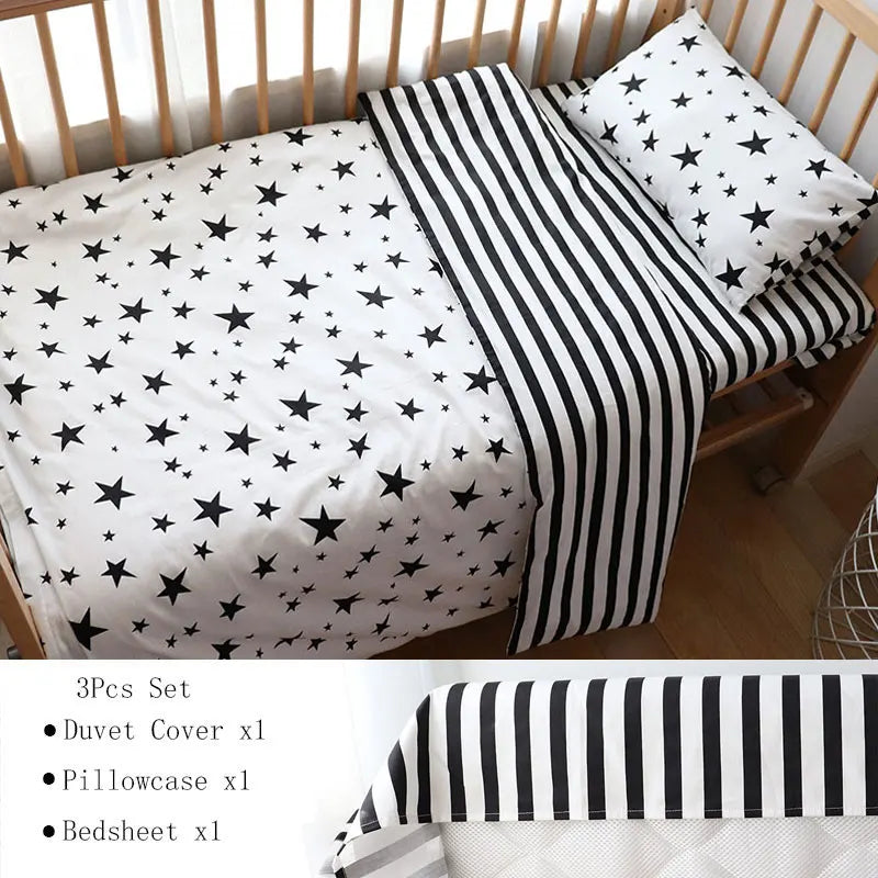 Black and white toddler bedding set with star-patterned duvet and pillowcase, plus a striped sheet. Includes 3 pieces: duvet cover, pillowcase, and bedsheet.