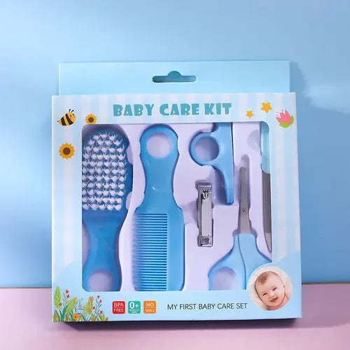 Blue baby care kit with brush, comb, scissors, nail clipper, and a file in a striped box labeled "Baby Care Kit." Decorated with flowers and baby photo. BPA free, 0+ months.