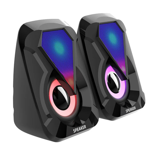 Two black speakers with angular designs feature colorful LED lights, displaying gradients of blue, purple, and red. The speakers are labeled "SPEAKER" at the bottom.