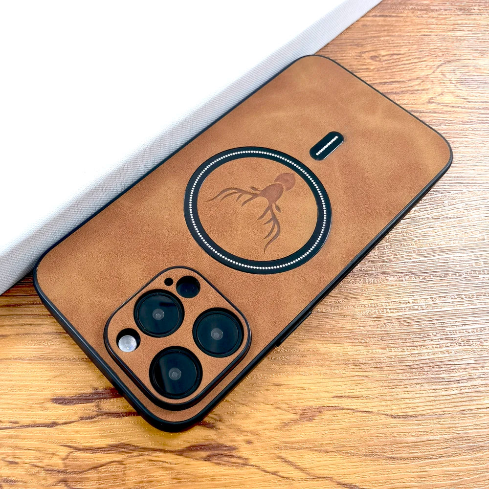 Brown phone case with an engraved octopus design, showcasing camera cutouts and a MagSafe ring, resting on a wooden surface next to a folded white paper.