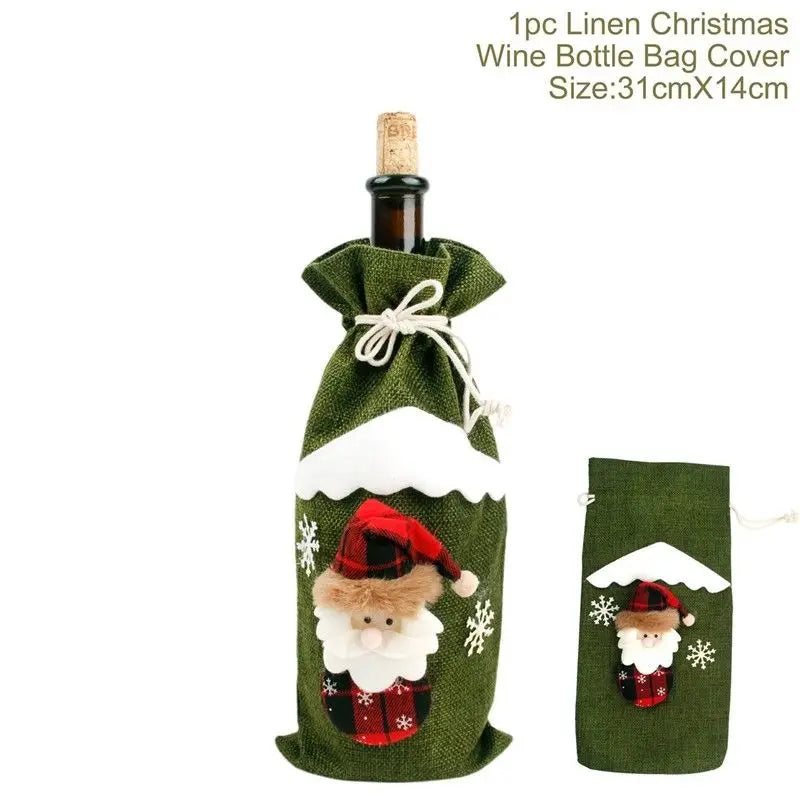 Green linen Christmas wine bottle cover with Santa design, white snow accents, and snowflakes. Includes drawstring closure. Size: 31cm x 14cm.