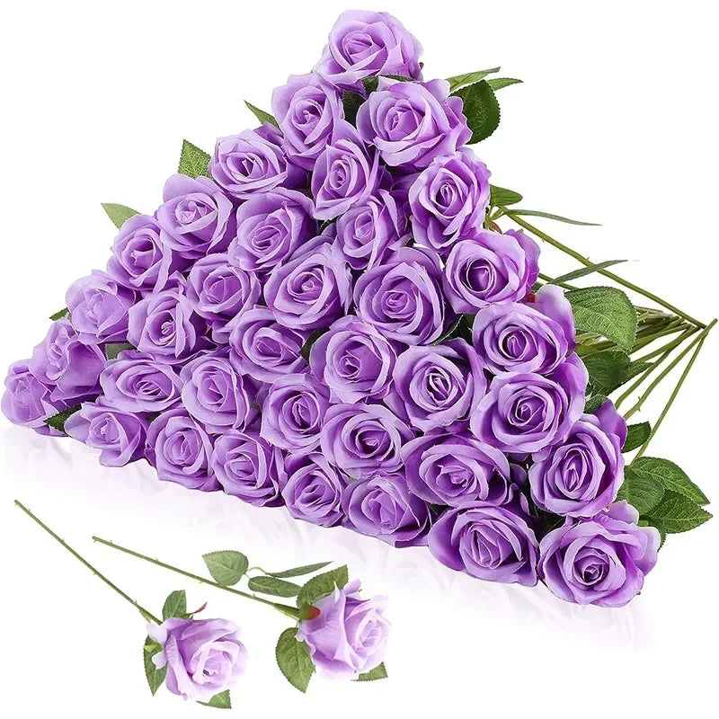 A bouquet of vibrant purple roses with green leaves is elegantly arranged in a triangular shape, with two individual roses placed in front.