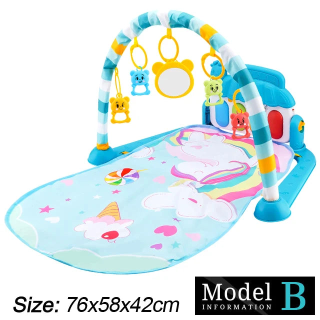 Colorful baby play mat with a unicorn design, featuring a striped arch with hanging toys and a mirror. Dimensions: 76x58x42cm. Model B branding in the corner.