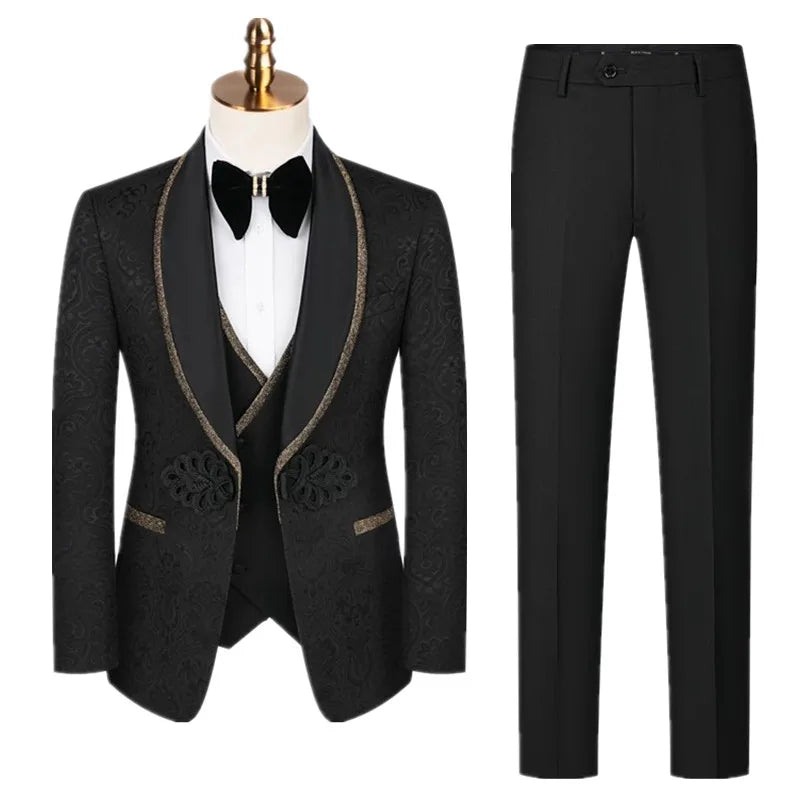 Elegant black suit with gold-trimmed shawl lapels, intricate patterned details, and matching pants. Includes white shirt and black bow tie on a mannequin.