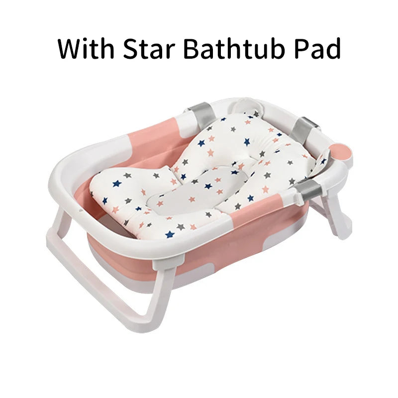 Baby bathtub with a cushioned pad featuring colorful stars. The tub is pink and white with sturdy handles and foldable legs. Text above reads, "With Star Bathtub Pad."