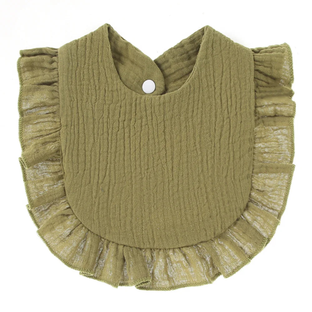 Olive green bib with a textured surface and ruffled edges. It features a white snap closure at the top, designed for easy fastening.