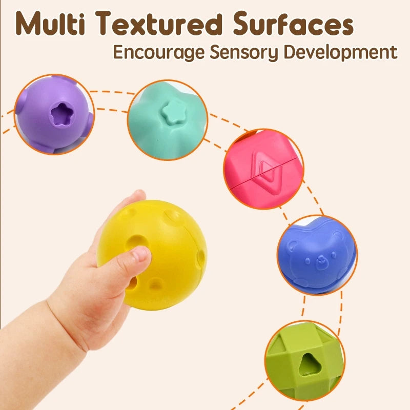 Child holding a yellow textured sensory ball. Surrounding are other colorful balls with various textures, encouraging sensory development. Text reads “Multi Textured Surfaces.”