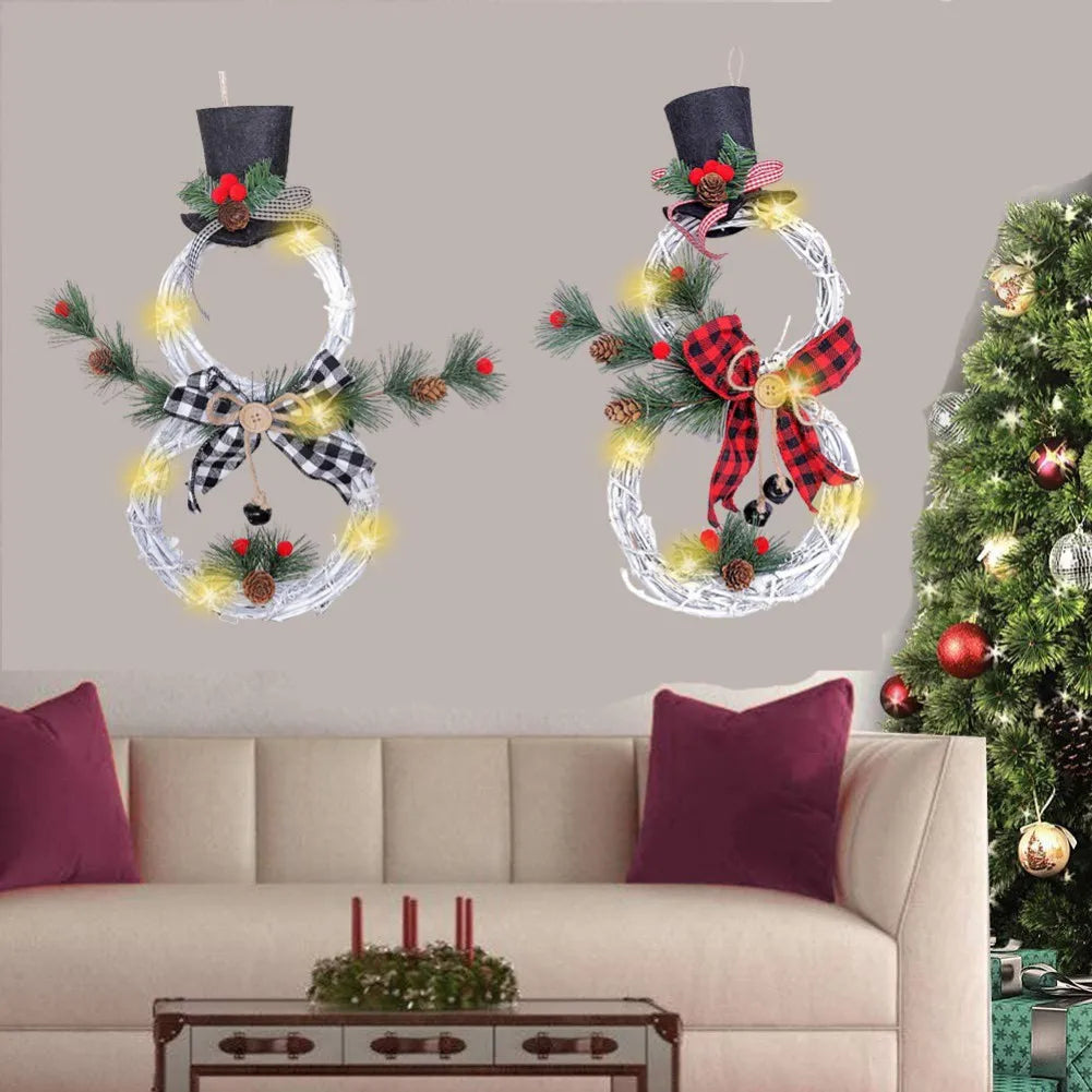 Festive holiday room with two illuminated snowman wreaths adorned with plaid bows and top hats, a white couch with red pillows, and a decorated Christmas tree.