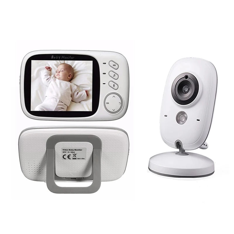 Baby monitor set with a white camera and handheld screen. The display shows a sleeping baby in white clothes. The camera has a lens and microphone on a swivel stand.